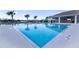 Sparkling community pool with clear blue water and plenty of lounge chairs for relaxation at 2820 Neverland Dr, New Smyrna Beach, FL 32168