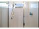 Bright, tiled shower features a shower head, handheld sprayer, and a window for natural light at 2820 Neverland Dr, New Smyrna Beach, FL 32168