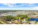 An aerial view of a home in a serene setting surrounded by lush greenery and a pond at 29 Promenade At Lionspaw, Daytona Beach, FL 32124