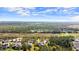 An aerial view of a home in a serene setting surrounded by lush greenery and a pond at 29 Promenade At Lionspaw, Daytona Beach, FL 32124