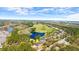 An aerial view of a home in a serene setting surrounded by lush greenery and a golf course at 29 Promenade At Lionspaw, Daytona Beach, FL 32124