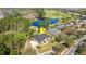 An aerial view of a home in a serene setting surrounded by lush greenery and a golf course at 29 Promenade At Lionspaw, Daytona Beach, FL 32124