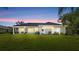 A lovely single-story home with a manicured lawn at dusk at 29 Promenade At Lionspaw, Daytona Beach, FL 32124