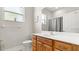 Bright bathroom featuring a vanity with wooden cabinets, a toilet, and a shower with a curtain at 29 Promenade At Lionspaw, Daytona Beach, FL 32124