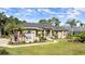 Attractive one-story home boasts lush greenery and inviting walkway at 29 Promenade At Lionspaw, Daytona Beach, FL 32124