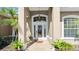 Elegant front entry featuring a decorative glass door, transom window and tiled porch at 29 Promenade At Lionspaw, Daytona Beach, FL 32124