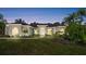 Charming home featuring a manicured lawn, lush landscaping, and a welcoming front entrance at 29 Promenade At Lionspaw, Daytona Beach, FL 32124