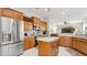Stylish kitchen featuring stainless steel appliances, wood cabinets, and granite countertops at 29 Promenade At Lionspaw, Daytona Beach, FL 32124