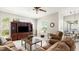 Inviting living room featuring a comfortable sectional sofa, dark wood entertainment center, and plenty of natural light at 29 Promenade At Lionspaw, Daytona Beach, FL 32124