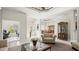 Bright, airy living room featuring tile flooring, tray ceilings, and a view of the dining area at 29 Promenade At Lionspaw, Daytona Beach, FL 32124