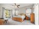 Bedroom featuring a large bed, natural light from sliding doors, and a view of the outdoor space and patio at 29 Promenade At Lionspaw, Daytona Beach, FL 32124