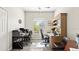 Bright home office with a large window providing natural light, complemented by two desk spaces and built in storage at 29 Promenade At Lionspaw, Daytona Beach, FL 32124