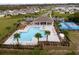 Community pool and splash pad surrounded by lounging areas and palm trees, creating a resort-like atmosphere at 2943 Gibraltar Blvd, New Smyrna Beach, FL 32168