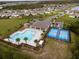 Aerial view of community pool, splash pad, playground, and pickleball courts, a hub of recreation at 2943 Gibraltar Blvd, New Smyrna Beach, FL 32168