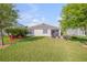 Expansive backyard featuring a well-maintained lawn, patio seating, and beautiful landscaping at 2943 Gibraltar Blvd, New Smyrna Beach, FL 32168