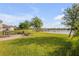 Serene backyard view with outdoor seating overlooking a tranquil pond, perfect for relaxation at 2943 Gibraltar Blvd, New Smyrna Beach, FL 32168