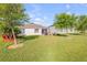 Backyard with a paver patio, palm trees, and well-maintained lawn at 2943 Gibraltar Blvd, New Smyrna Beach, FL 32168