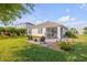Backyard with comfortable seating, outdoor dining set and a screened in patio at 2943 Gibraltar Blvd, New Smyrna Beach, FL 32168