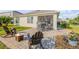 Paver patio with comfortable seating and outdoor dining set near the screened patio at 2943 Gibraltar Blvd, New Smyrna Beach, FL 32168