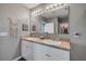 Dual sinks sit below a big mirror in this bathroom at 2943 Gibraltar Blvd, New Smyrna Beach, FL 32168