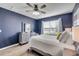 A well-lit bedroom features a plush bed, neutral walls, and a modern ceiling fan at 2943 Gibraltar Blvd, New Smyrna Beach, FL 32168