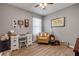 Inviting bedroom with a comfortable chair, desk, and natural light from the window at 2943 Gibraltar Blvd, New Smyrna Beach, FL 32168