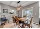 Comfortable dining room with a wooden table set, stylish decor, and backyard views through sliding glass doors at 2943 Gibraltar Blvd, New Smyrna Beach, FL 32168