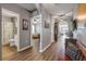 Long foyer with hardwood floors, opening to a bathroom, bedroom, and living area at 2943 Gibraltar Blvd, New Smyrna Beach, FL 32168