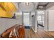 Inviting foyer with hardwood floors, bench seating, and view into the bedroom at 2943 Gibraltar Blvd, New Smyrna Beach, FL 32168