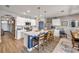 Modern kitchen features an island with seating, sleek white cabinets and stainless appliances at 2943 Gibraltar Blvd, New Smyrna Beach, FL 32168