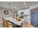 Open kitchen features a large island with seating, quartz countertops and stainless steel appliances at 2943 Gibraltar Blvd, New Smyrna Beach, FL 32168