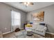 Bright living room with a comfortable sofa, soft rug, and an artistic wall painting at 2943 Gibraltar Blvd, New Smyrna Beach, FL 32168