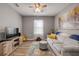 Cozy living room with a comfortable sofa, TV, and soft lighting from the ceiling fan at 2943 Gibraltar Blvd, New Smyrna Beach, FL 32168