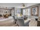 Comfortable living room with a view into the dining area, featuring neutral tones, stylish furniture, and lots of natural light at 2943 Gibraltar Blvd, New Smyrna Beach, FL 32168