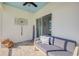 Paver patio offers comfortable seating, ceiling fan and decorative wall hanging at 2943 Gibraltar Blvd, New Smyrna Beach, FL 32168