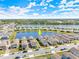 Aerial view showcasing a home by a lake within a picturesque community at 2951 Meleto Blvd, New Smyrna Beach, FL 32168