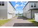 View of driveways leading to garages between two houses and a peaceful lake beyond at 2951 Meleto Blvd, New Smyrna Beach, FL 32168