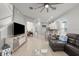 Open-concept living room with tile floors, a ceiling fan, and modern furnishings at 2951 Meleto Blvd, New Smyrna Beach, FL 32168