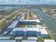 An aerial view shows the condo complex with waterfront access, boat docks, parking, and a refreshing community pool at 315 N Causeway # C402, New Smyrna Beach, FL 32169