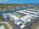Stunning aerial view of the condo community nestled along the waterfront, featuring a pool and lush greenery at 315 N Causeway # C402, New Smyrna Beach, FL 32169