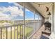 Screened balcony offering views of lawn, pool and nearby condo buildings at 315 N Causeway # C402, New Smyrna Beach, FL 32169