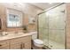 Well-lit bathroom with a glass-enclosed shower, vanity and modern fixtures at 315 N Causeway # C402, New Smyrna Beach, FL 32169