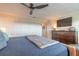 Well-lit bedroom features a ceiling fan, a large closet and warm neutral tones at 315 N Causeway # C402, New Smyrna Beach, FL 32169