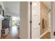 Hallway leading to the balcony, showing wood floors, bathroom and natural light at 315 N Causeway # C402, New Smyrna Beach, FL 32169