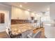Modern kitchen with granite countertops, white cabinets, and stainless steel appliances at 315 N Causeway # C402, New Smyrna Beach, FL 32169