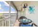 Relaxing outdoor lanai with wicker furniture and view of the community from a screened in space at 315 N Causeway # C402, New Smyrna Beach, FL 32169