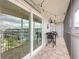 Cozy lanai area with comfortable seating, a brick floor, and a view of the community at 315 N Causeway # C402, New Smyrna Beach, FL 32169