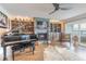 Inviting living room featuring a fireplace, piano, and custom built-ins at 315 N Causeway # C402, New Smyrna Beach, FL 32169