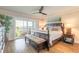 Beautiful main bedroom with hardwood floors, ceiling fan, and balcony access at 315 N Causeway # C402, New Smyrna Beach, FL 32169