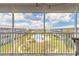 Beautiful community view overlooking the pool and green space from a screened lanai at 315 N Causeway # C402, New Smyrna Beach, FL 32169